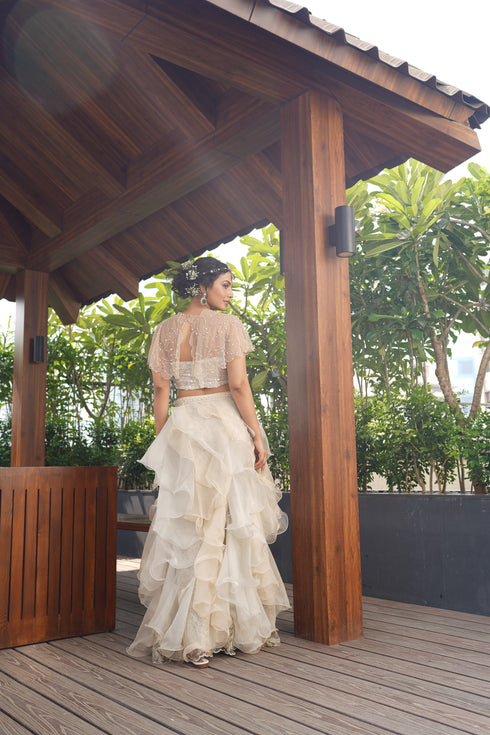 Cape with ruffle skirt